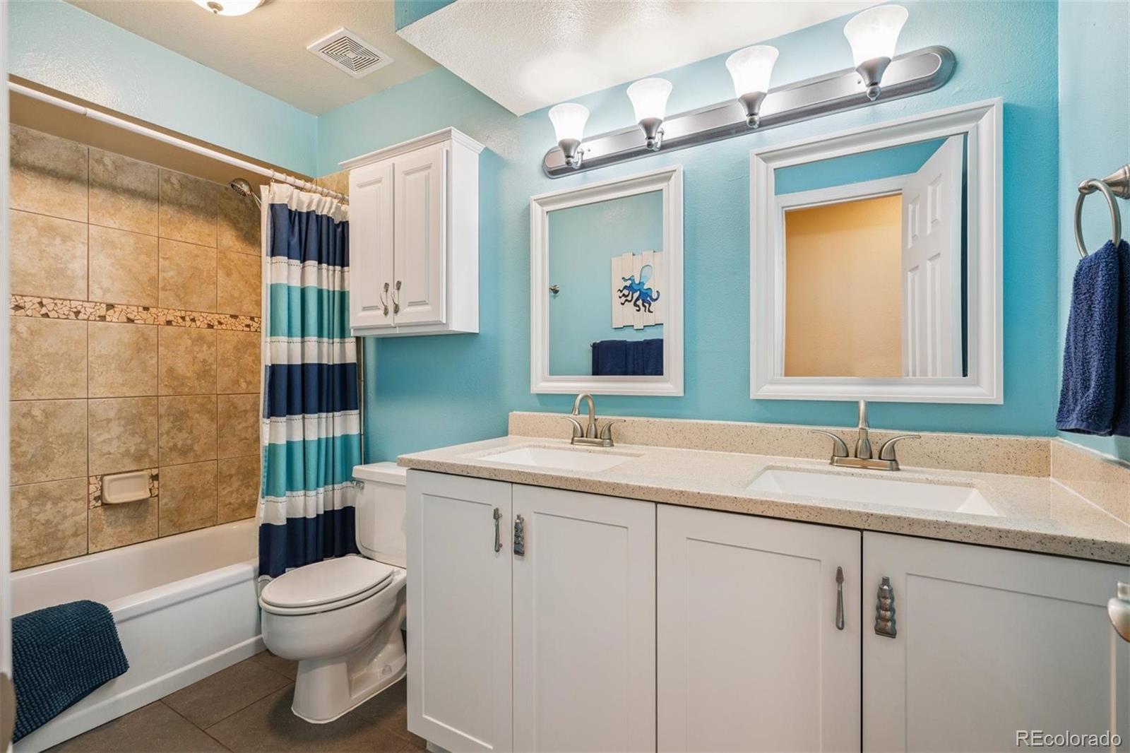 7659 South Fillmore Way Centennial, CO 80122 - Photo 23 of 45 a bathroom with a sink a toilet and shower