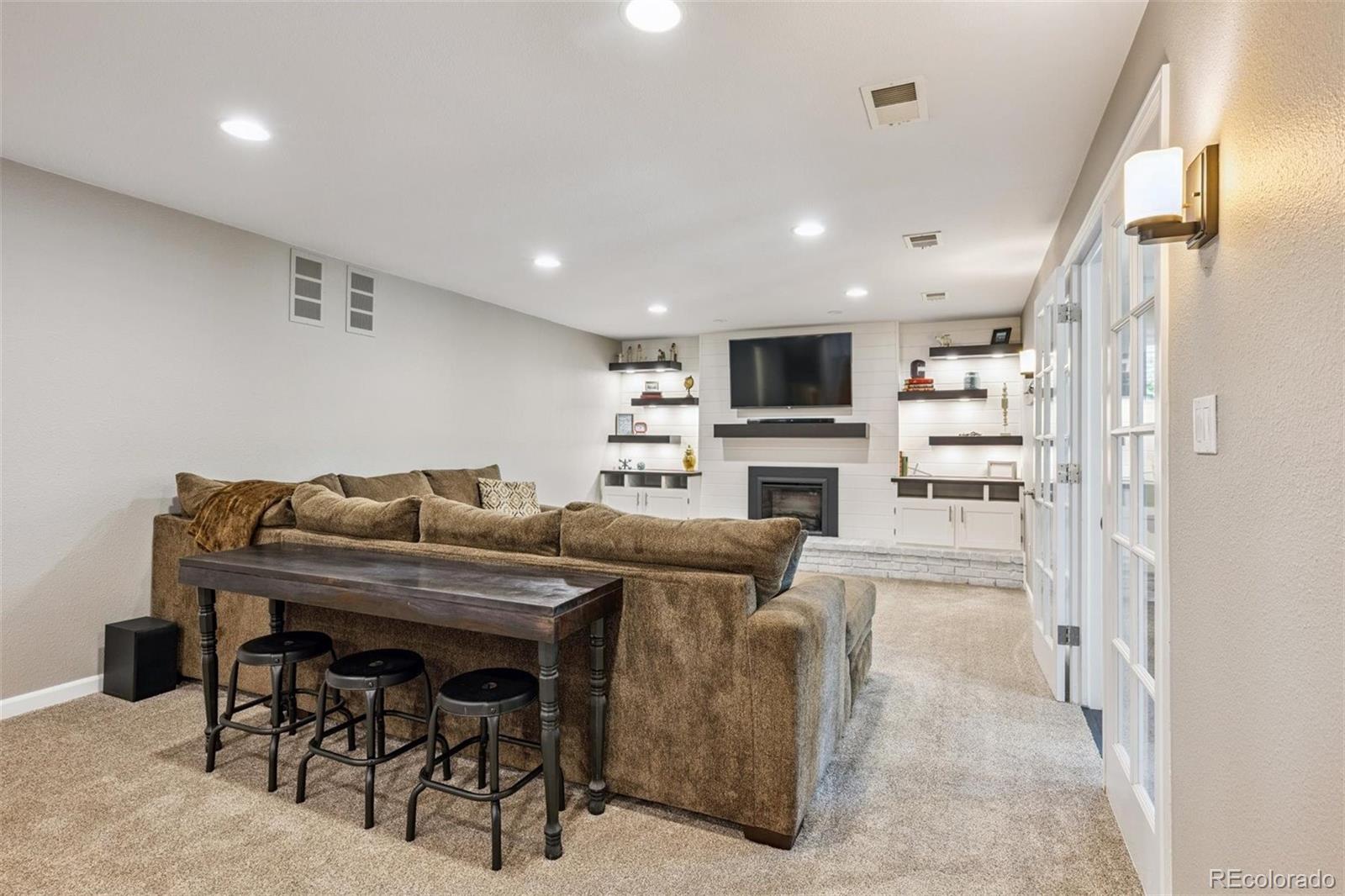 7659 South Fillmore Way Centennial, CO 80122 - Photo 25 of 45 a kitchen with stainless steel appliances kitchen island granite countertop a refrigerator and a stove top oven