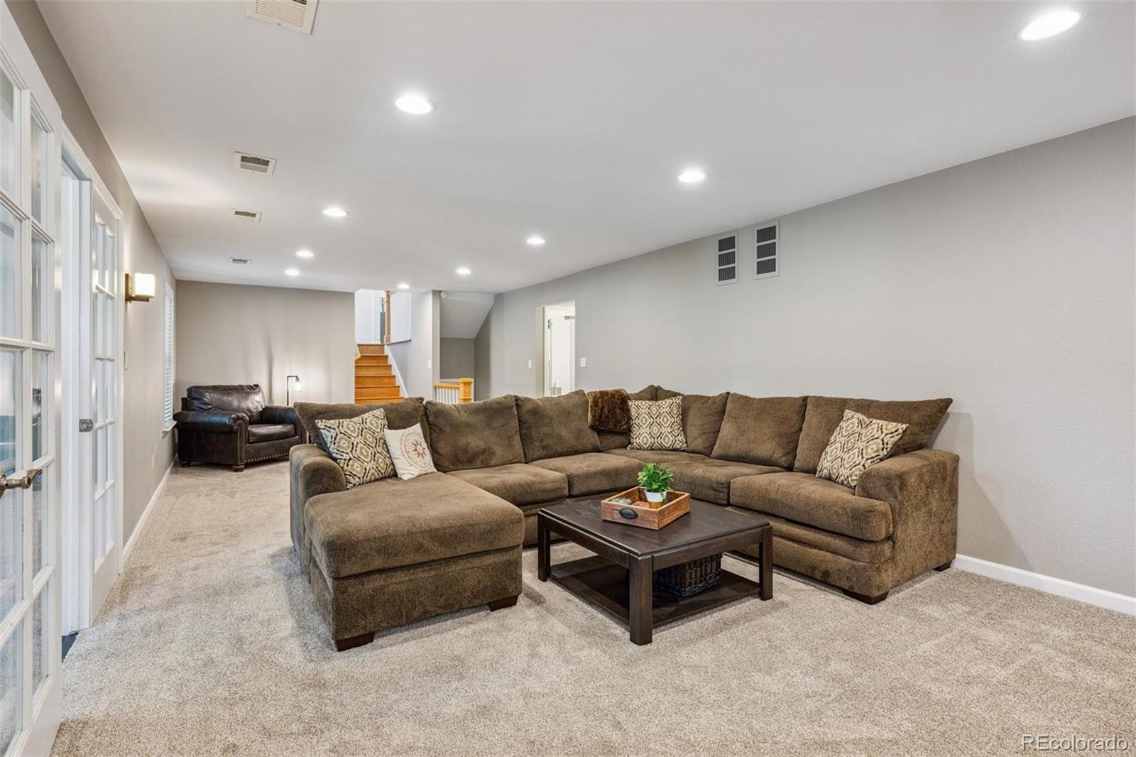 7659 South Fillmore Way Centennial, CO 80122 - Photo 26 of 45 a living room with furniture and a view of kitchen