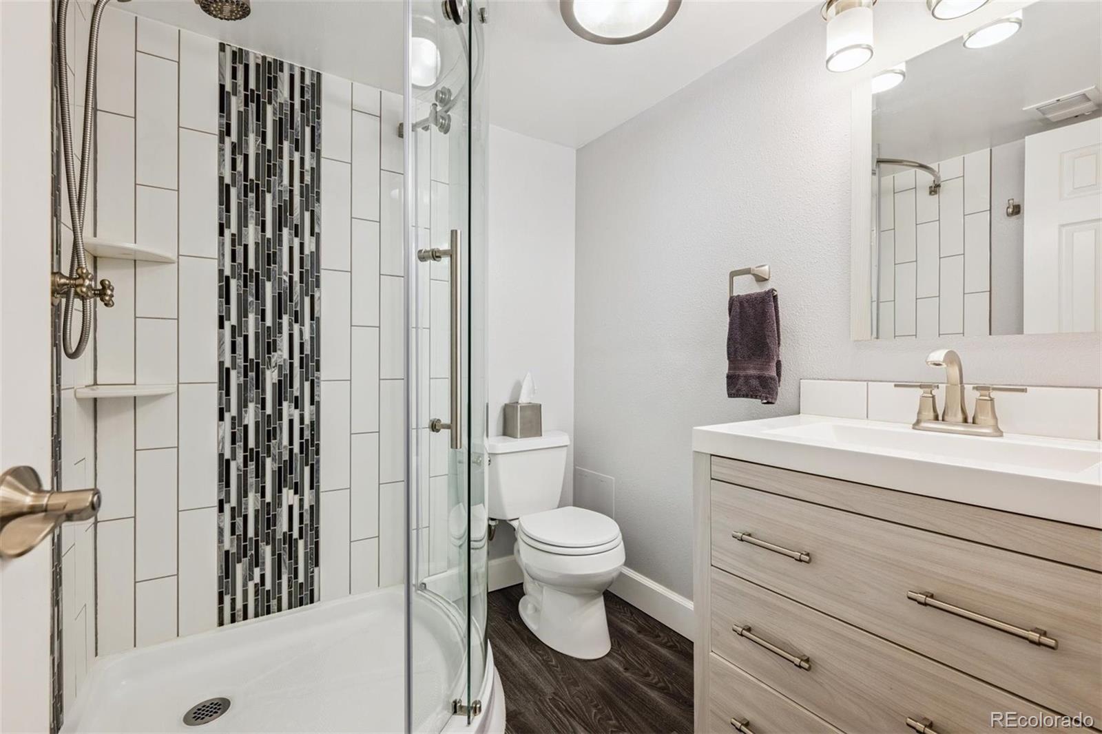 7659 South Fillmore Way Centennial, CO 80122 - Photo 28 of 45 a bathroom with a sink a toilet and shower