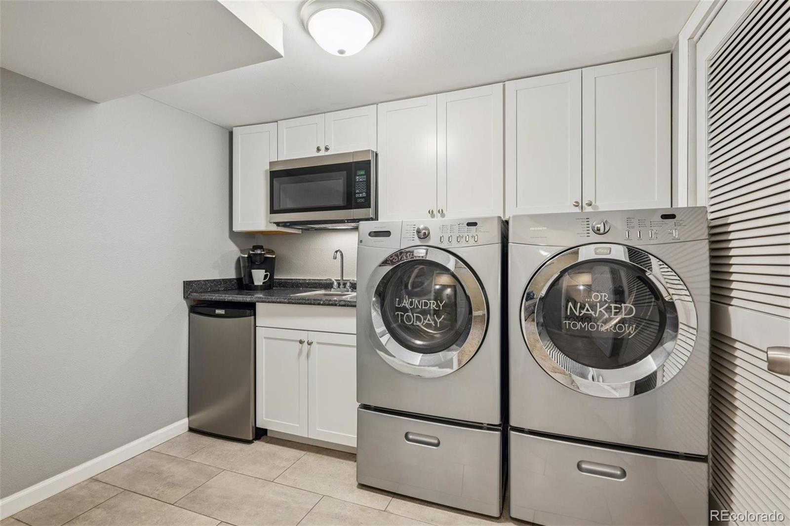 7659 South Fillmore Way Centennial, CO 80122 - Photo 31 of 45 a view of a storage and utility room with washer and dryer