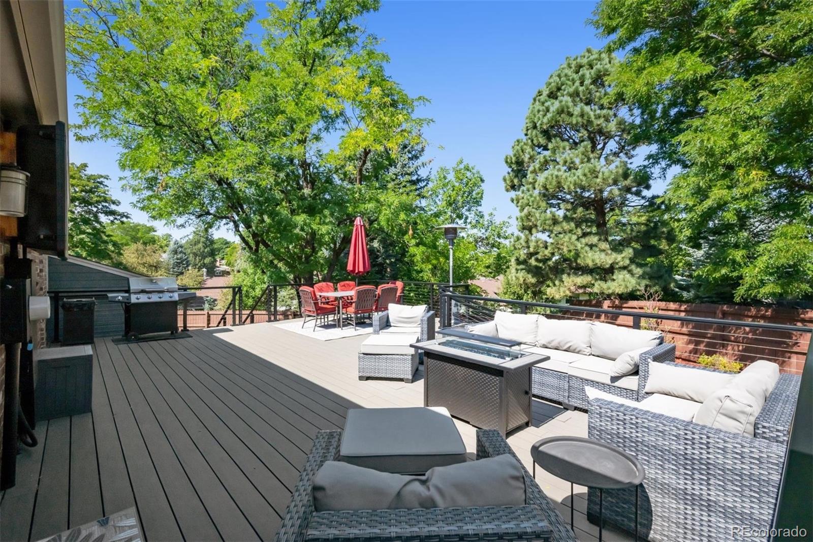 7659 South Fillmore Way Centennial, CO 80122 - Photo 35 of 45 a view of a patio with couches dining table and chairs with wooden floor