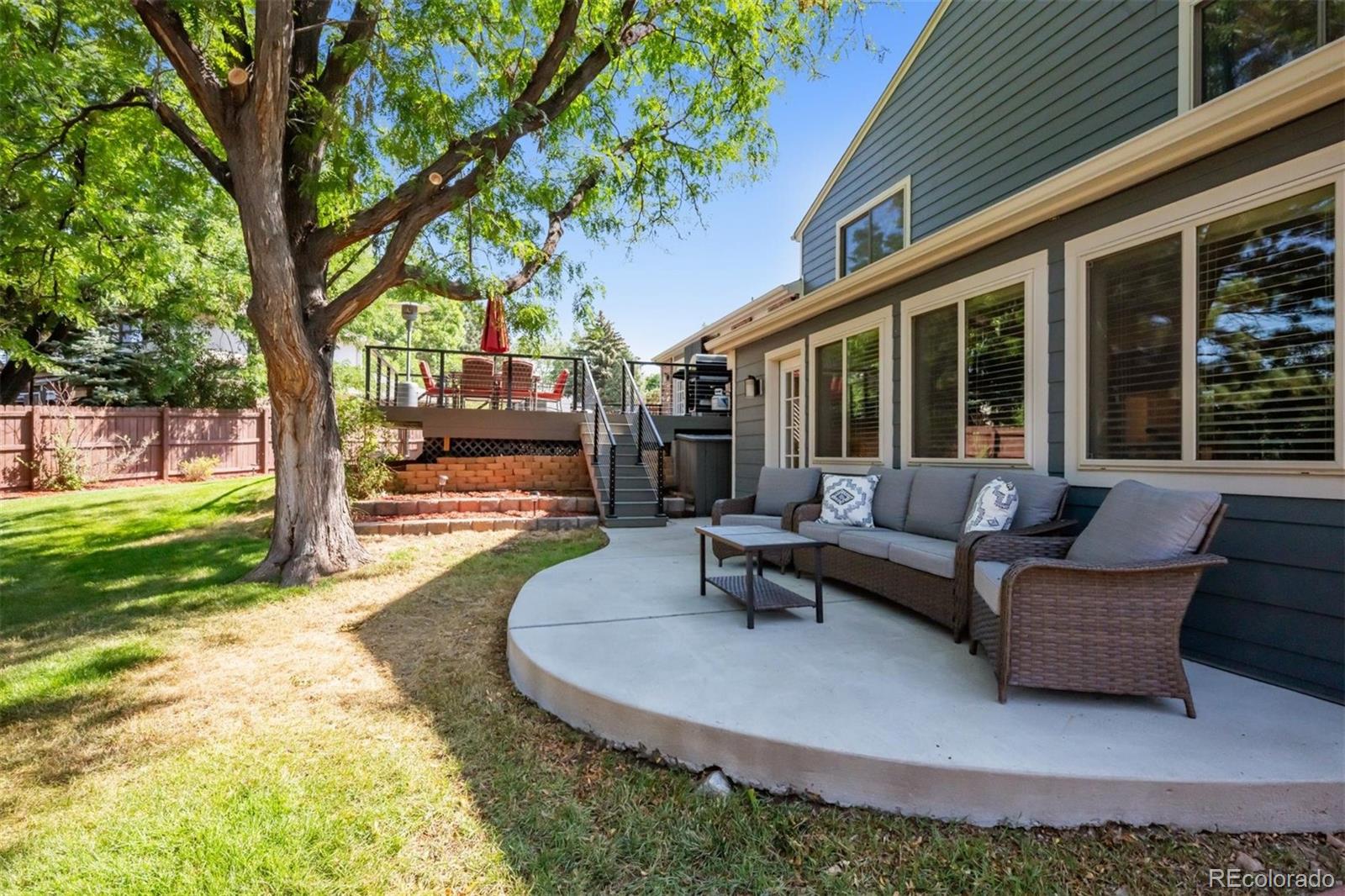 7659 South Fillmore Way Centennial, CO 80122 - Photo 37 of 45 a view of a patio with couches and a table and chairs with garden view