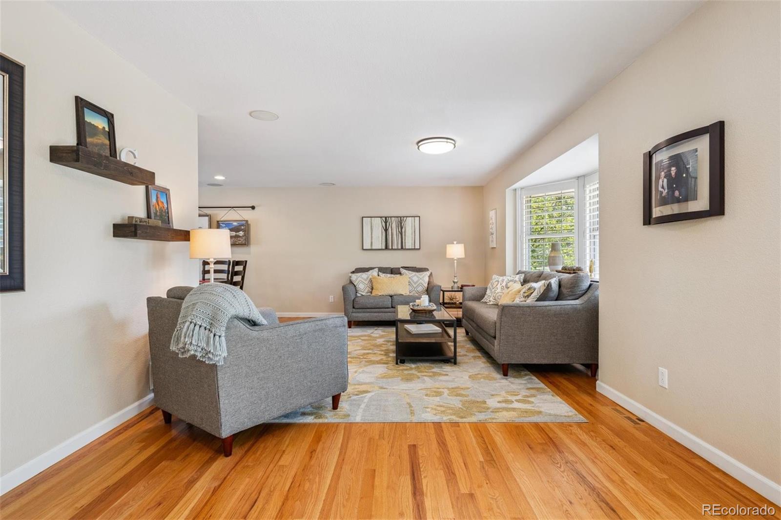 7659 South Fillmore Way Centennial, CO 80122 - Photo 5 of 45 a living room with furniture and a wooden floor