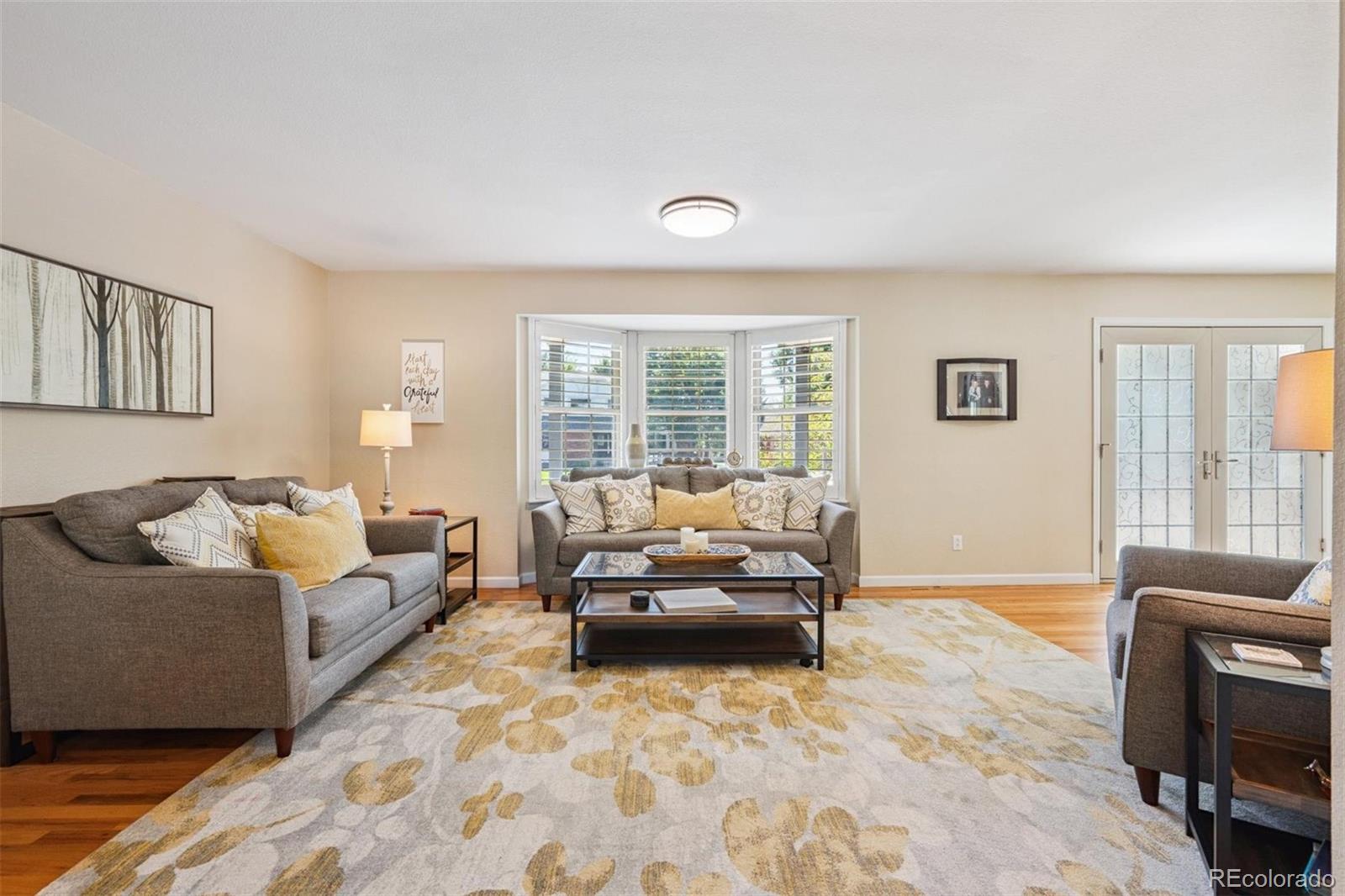 7659 South Fillmore Way Centennial, CO 80122 - Photo 6 of 45 a living room with furniture and a flat screen tv