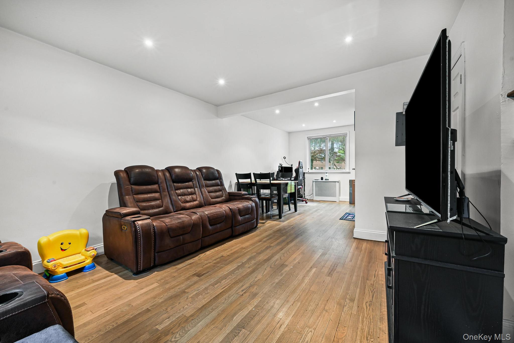 67-09 218th Street, Unit DUPLEX Queens, NY 11364 - Photo 4 of 22 a living room with furniture and a flat screen tv