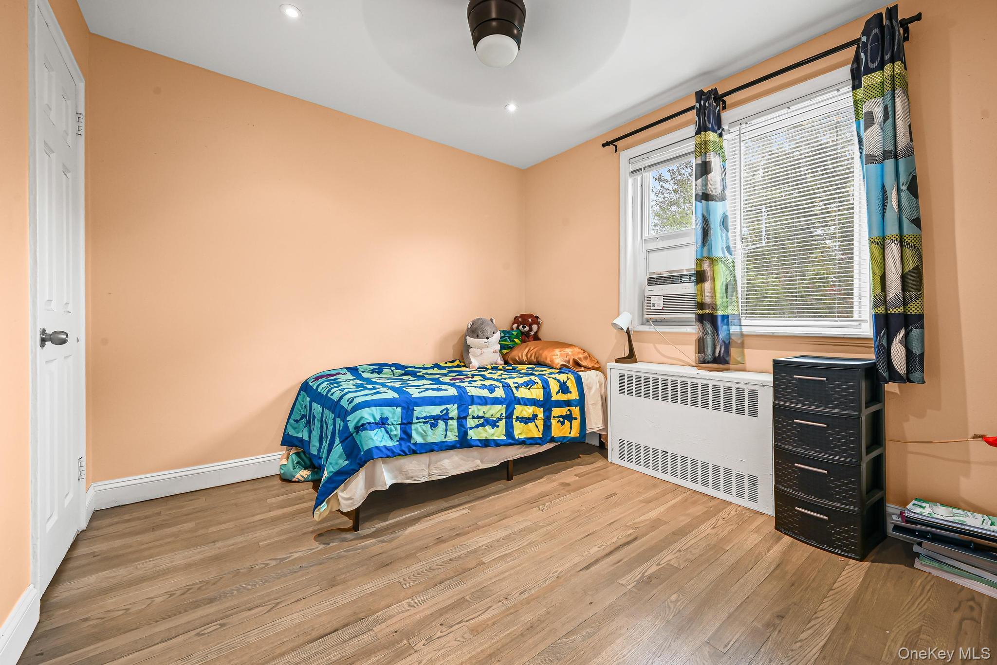 67-09 218th Street, Unit DUPLEX Queens, NY 11364 - Photo 10 of 22 a bedroom with a bed and a window