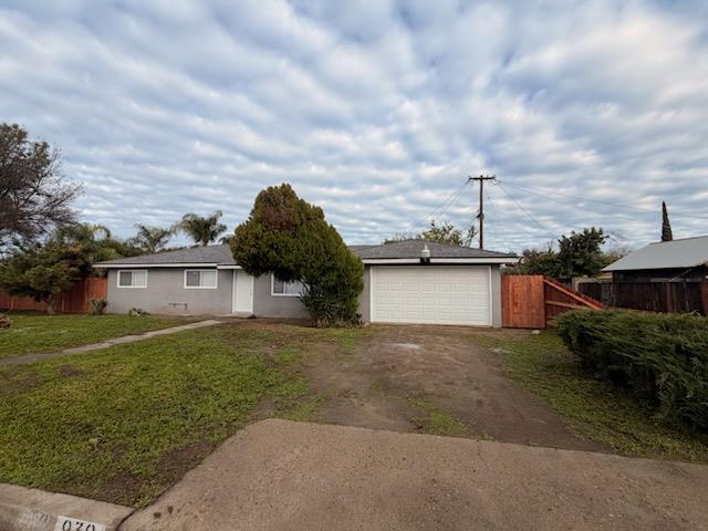 930 I Street Sanger, CA 93657 - Photo 2 of 15 a view of a house with a yard and large tree