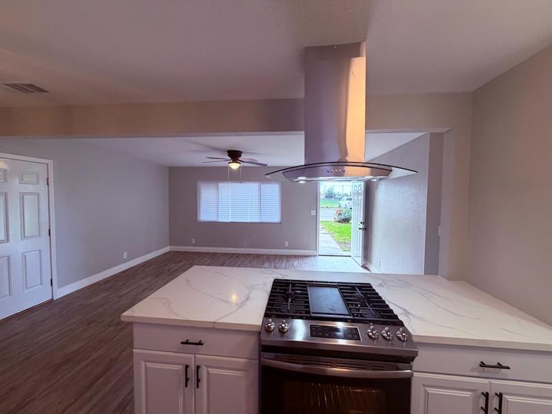 930 I Street Sanger, CA 93657 - Photo 10 of 15 a kitchen with a stove and a window