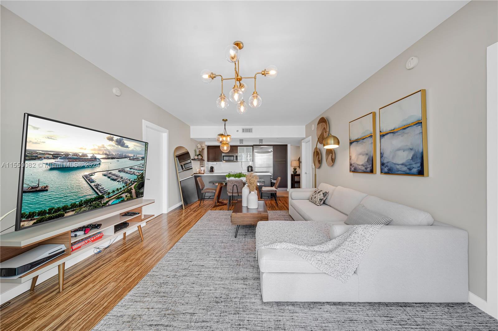 Brickell Miami, FL 33131 - Photo 12 of 61 a living room with furniture and a flat screen tv