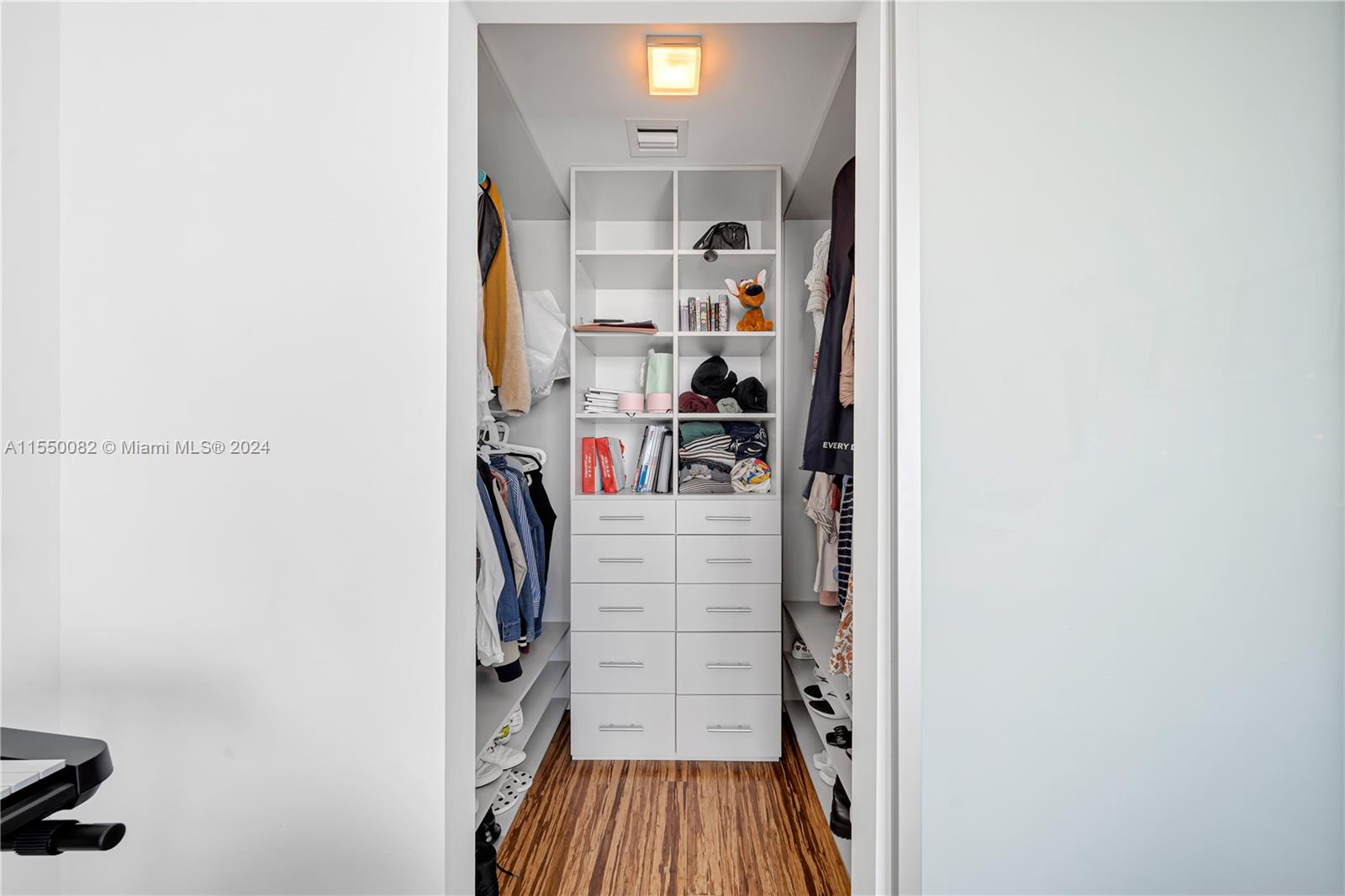 Brickell Miami, FL 33131 - Photo 17 of 61 a view of walk in closet with clothes and shoes