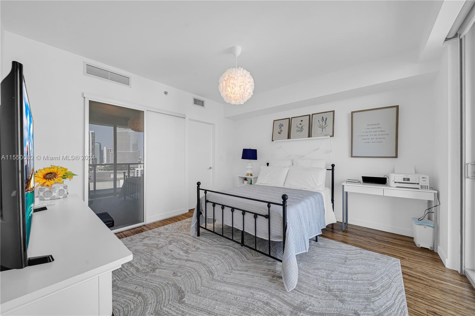 Brickell Miami, FL 33131 - Photo 18 of 61 a spacious bedroom with a bed and a chandelier