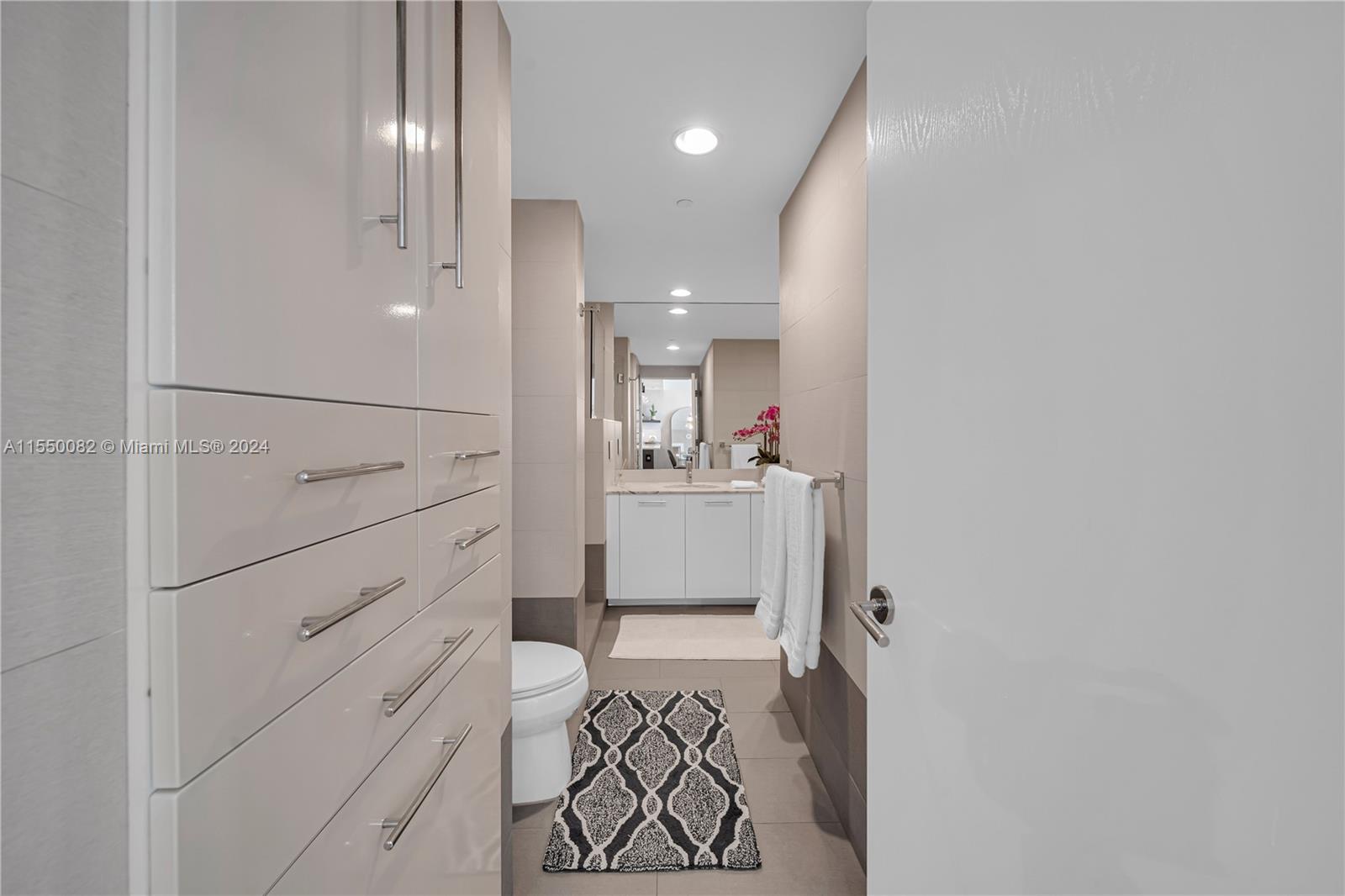 Brickell Miami, FL 33131 - Photo 22 of 61 a view of a hallway with closet and wooden floor