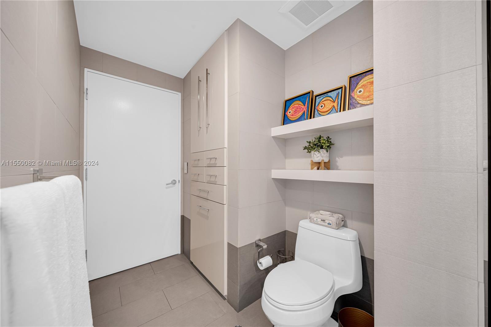 Brickell Miami, FL 33131 - Photo 29 of 61 a white toilet sitting next to a bathroom sink