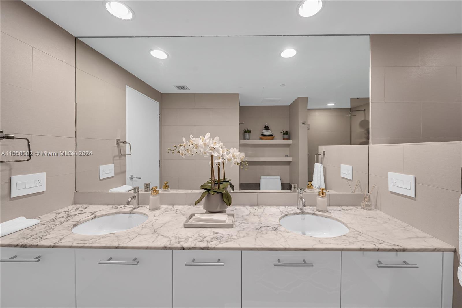 Brickell Miami, FL 33131 - Photo 37 of 61 a bathroom with double sink and a mirror