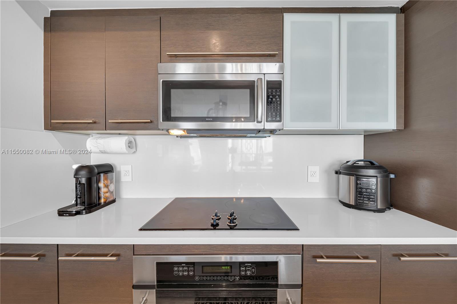 Brickell Miami, FL 33131 - Photo 5 of 61 a kitchen with a stove and a microwave