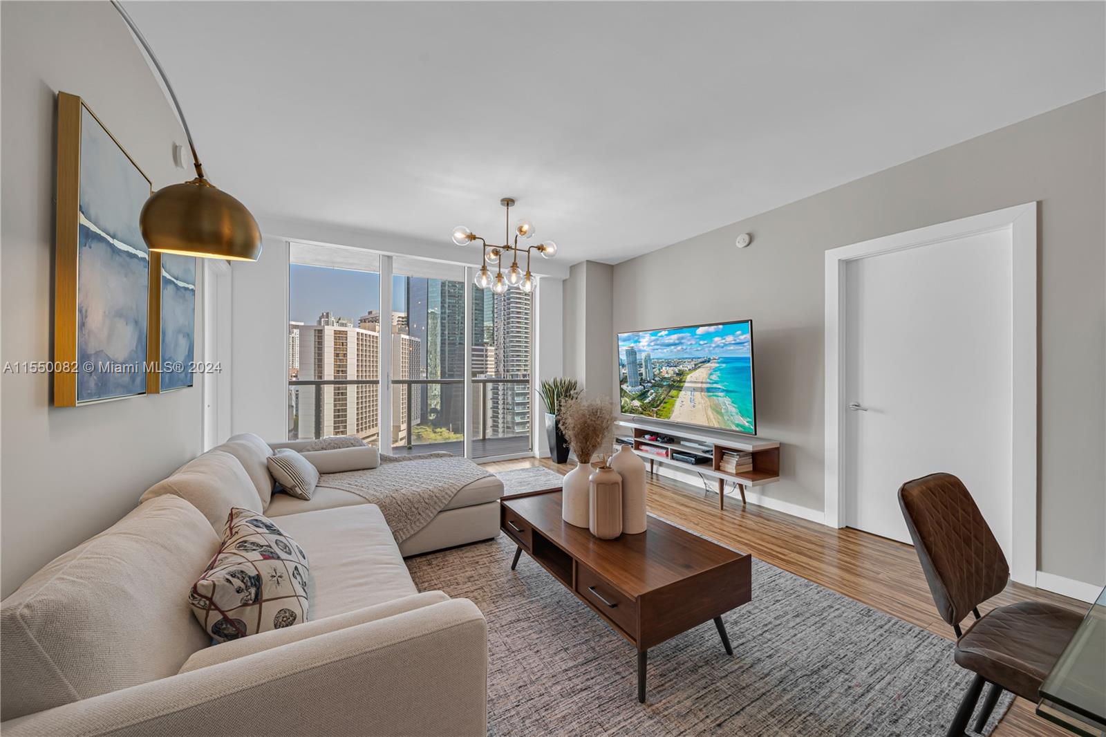 Brickell Miami, FL 33131 - Photo 9 of 61 a living room with furniture and a flat screen tv