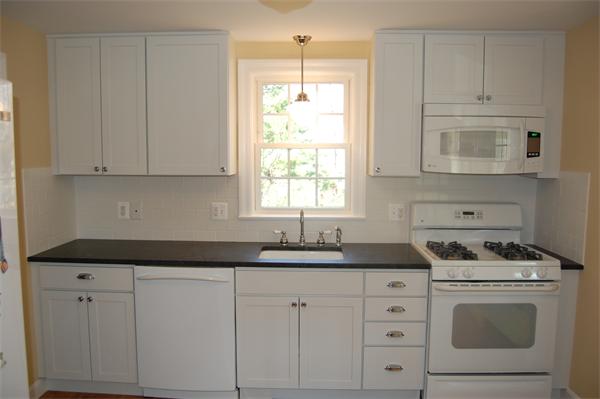 45 Clifton Road Milton, MA 02186 - Photo 2 of 19 a kitchen with white cabinets and white appliances
