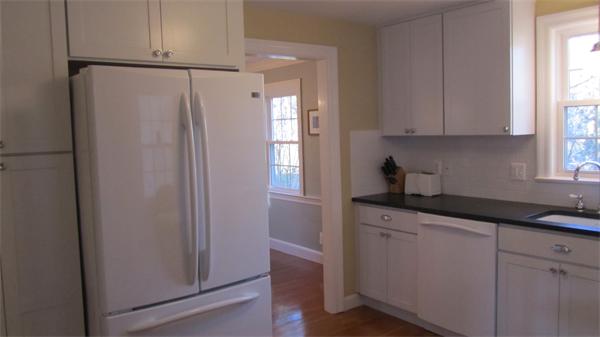 45 Clifton Road Milton, MA 02186 - Photo 3 of 19 a kitchen with granite countertop cabinets and refrigerator