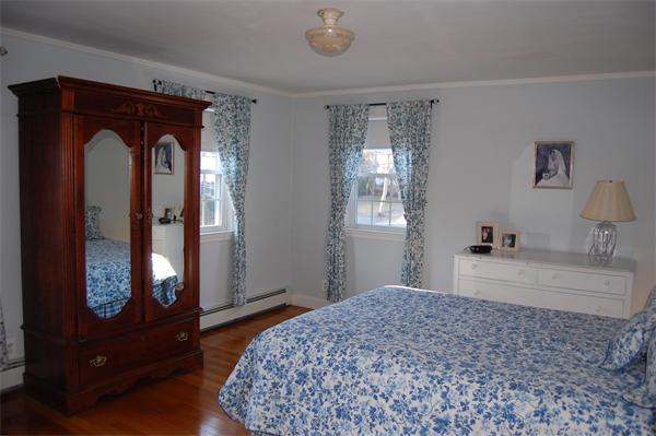 45 Clifton Road Milton, MA 02186 - Photo 10 of 19 a bedroom with a bed and a dresser with mirror