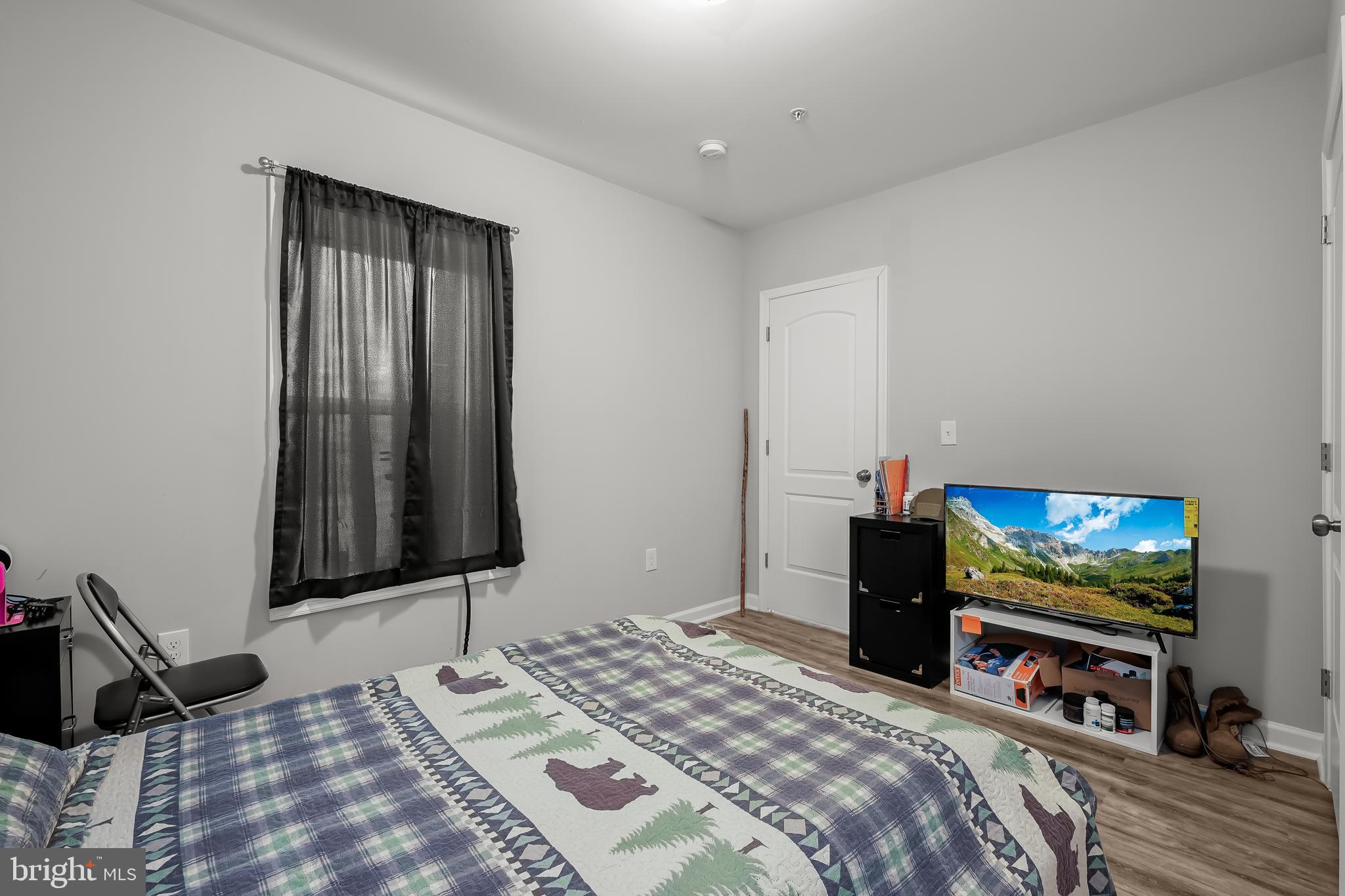 714 Manning Road East Accokeek, MD 20607 - Photo 8 of 47 a bedroom with a bed and a flat screen tv
