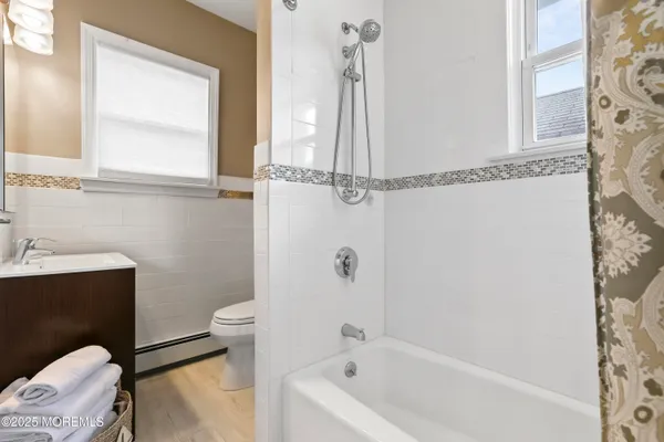a bathroom with a sink a toilet and bathtub
