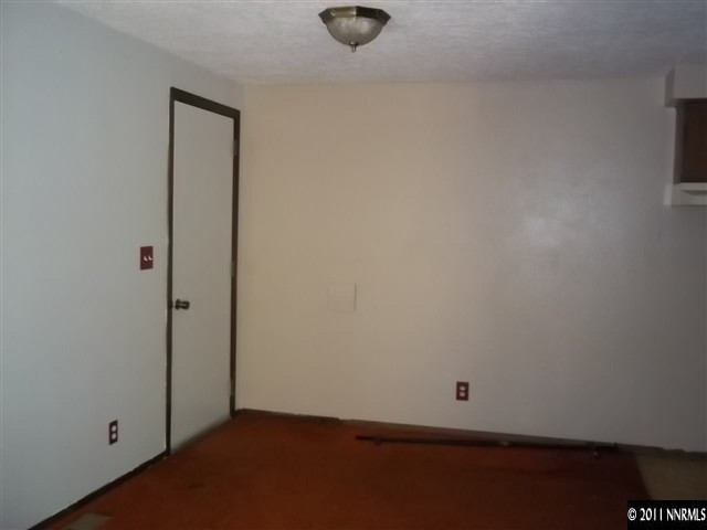 6865 Lotus Street Reno, NV 89506 - Photo 2 of 9 an empty room with wooden floor