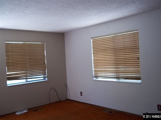 6865 Lotus Street Reno, NV 89506 - Photo 7 of 9 a view of an empty room with a window