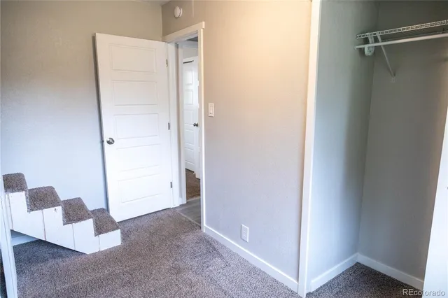a view of walk in closet with hardwood floor