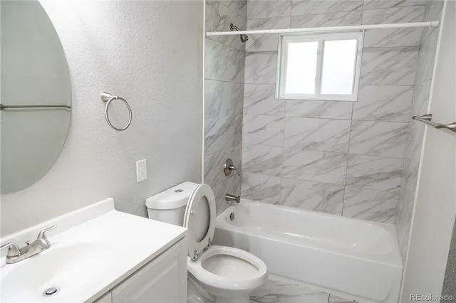 a bathroom with a toilet sink and bathtub