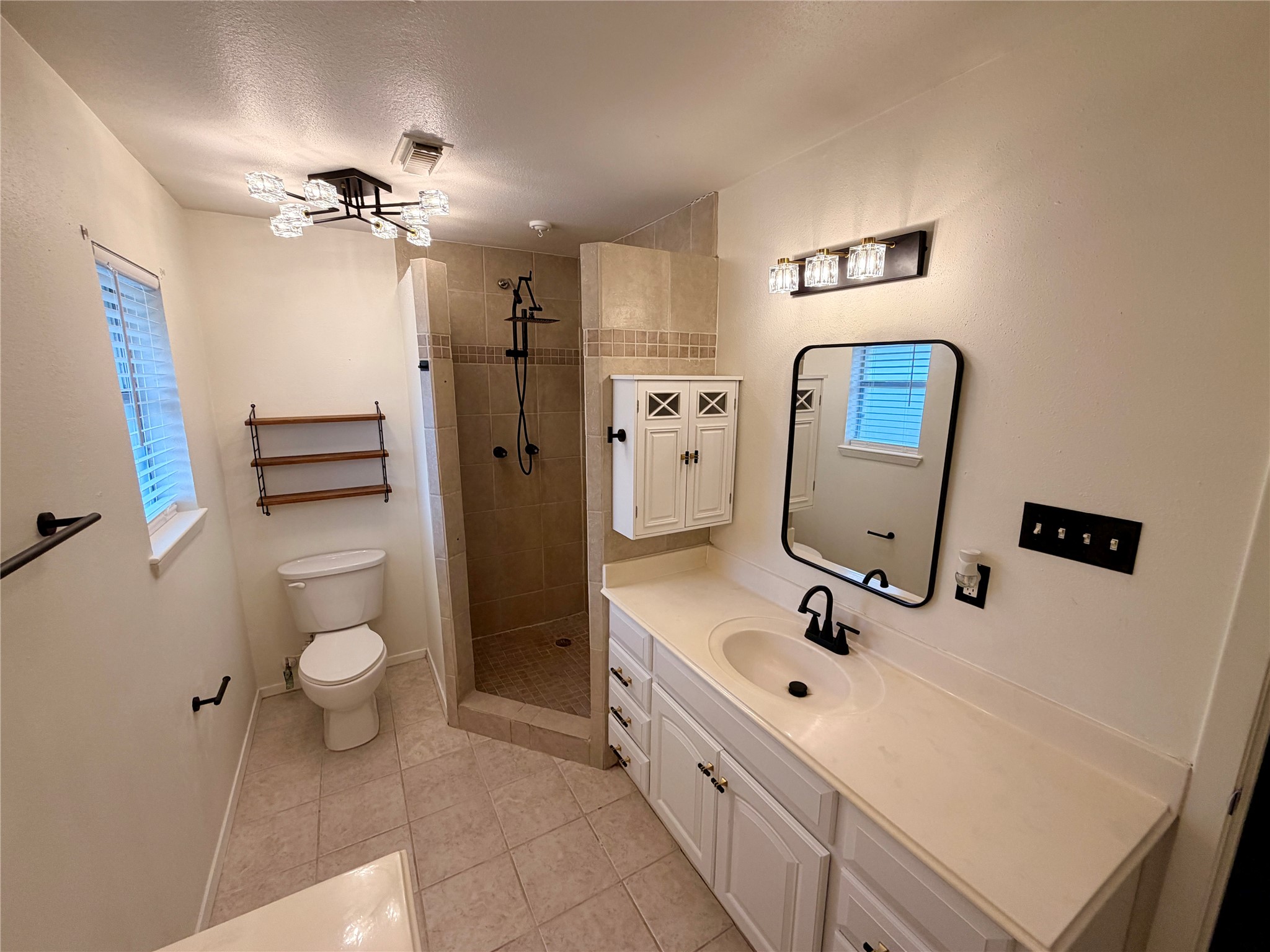 1411 Neptune Lane Houston, TX 77062 - Photo 12 of 23 a bathroom with a double vanity sink a toilet and a mirror