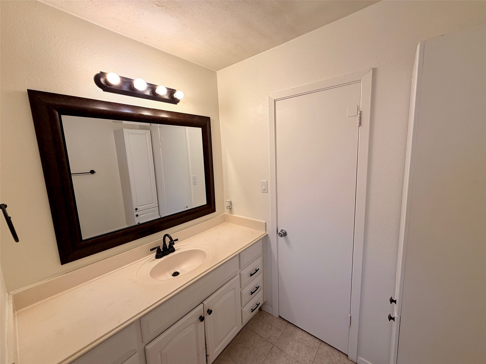 1411 Neptune Lane Houston, TX 77062 - Photo 18 of 23 a bathroom with a sink and a mirror