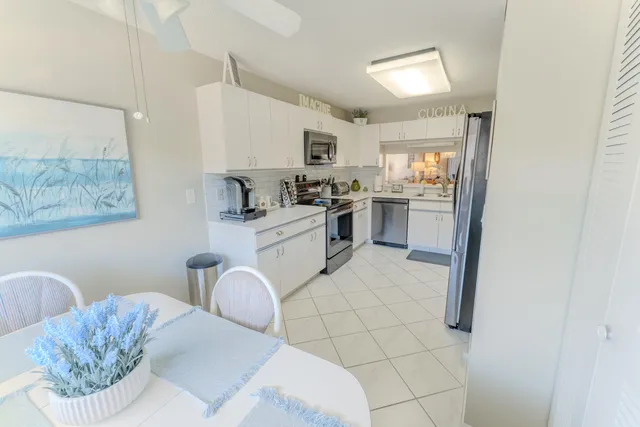 a kitchen with stainless steel appliances granite countertop a sink and a refrigerator