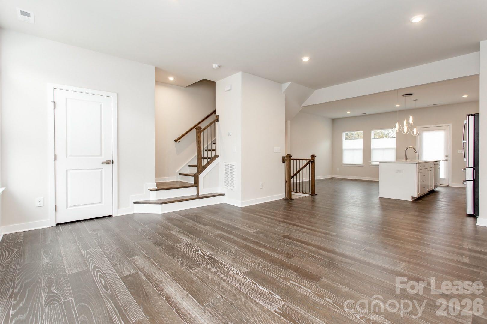 657 Uwharrie River Road Charlotte, NC 28211 - Photo 12 of 16 a view of empty room with wooden floor and kitchen