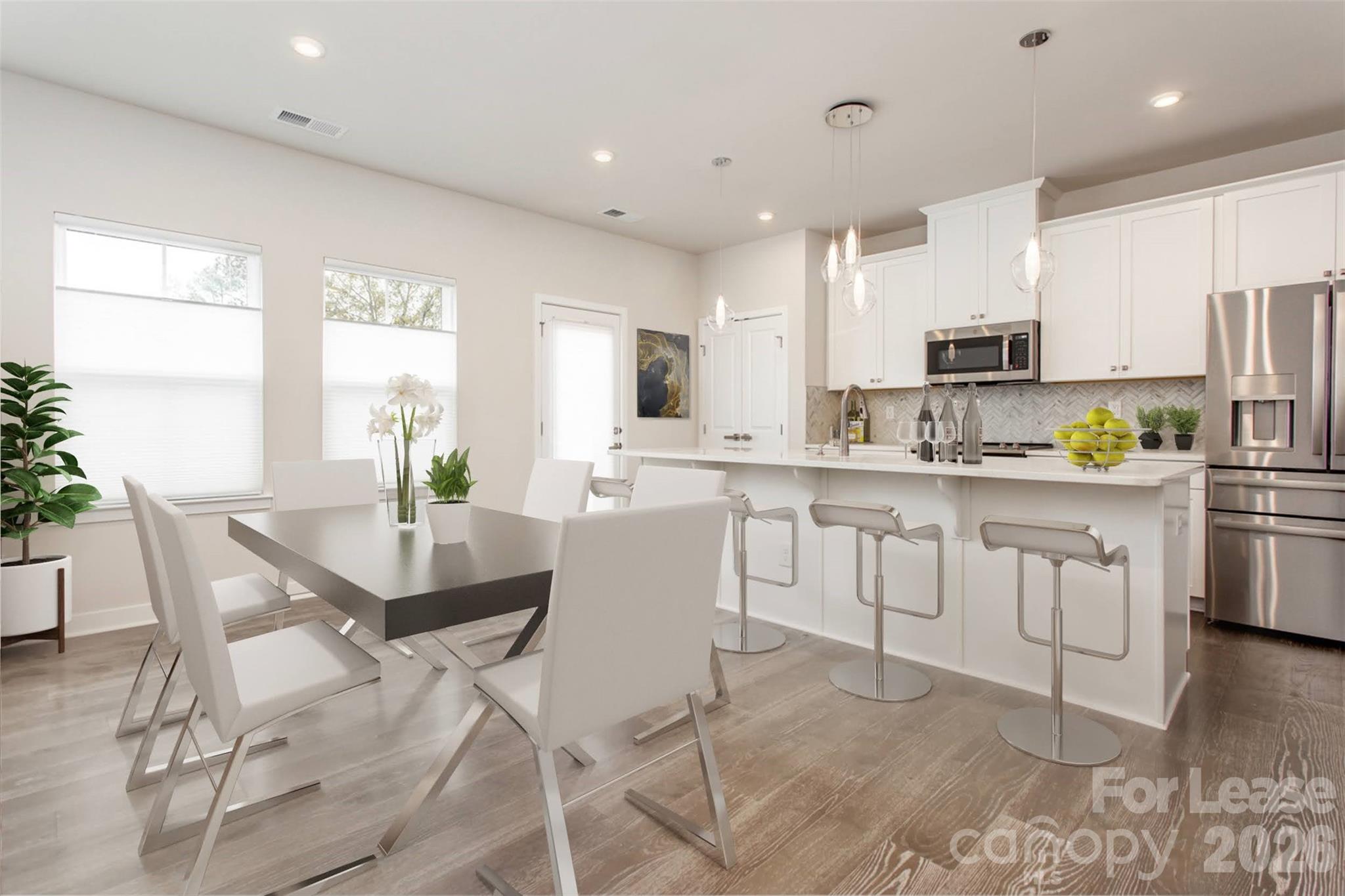 657 Uwharrie River Road Charlotte, NC 28211 - Photo 5 of 16 a kitchen with white cabinets and stainless steel appliances