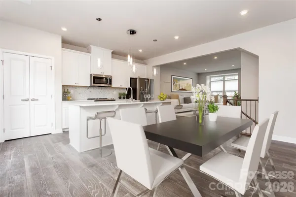 a kitchen with kitchen island a appliances a table and chairs in it