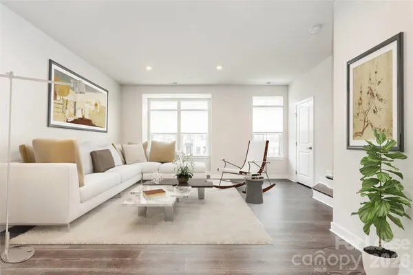 a living room with furniture or couch and a potted plant