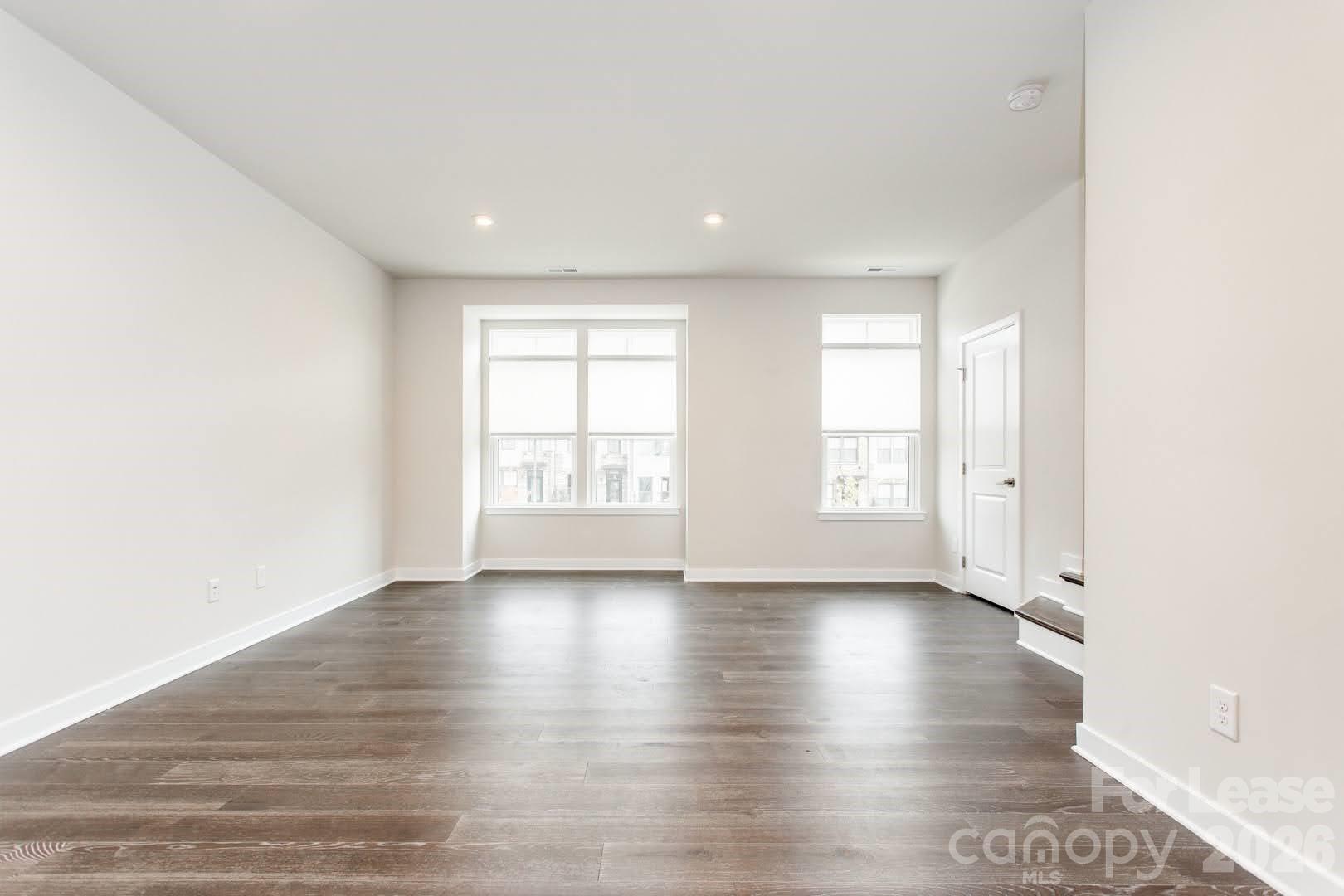 657 Uwharrie River Road Charlotte, NC 28211 - Photo 10 of 16 an empty room with wooden floor and windows
