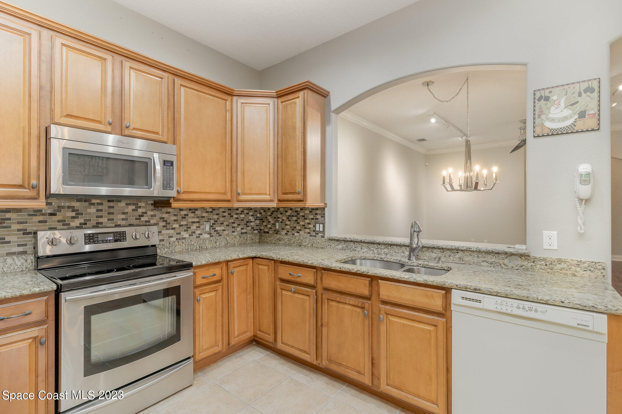 4250 Alamanda Key Drive Melbourne, FL 32901 - Photo 13 of 33 a kitchen with granite countertop cabinets stainless steel appliances and a sink