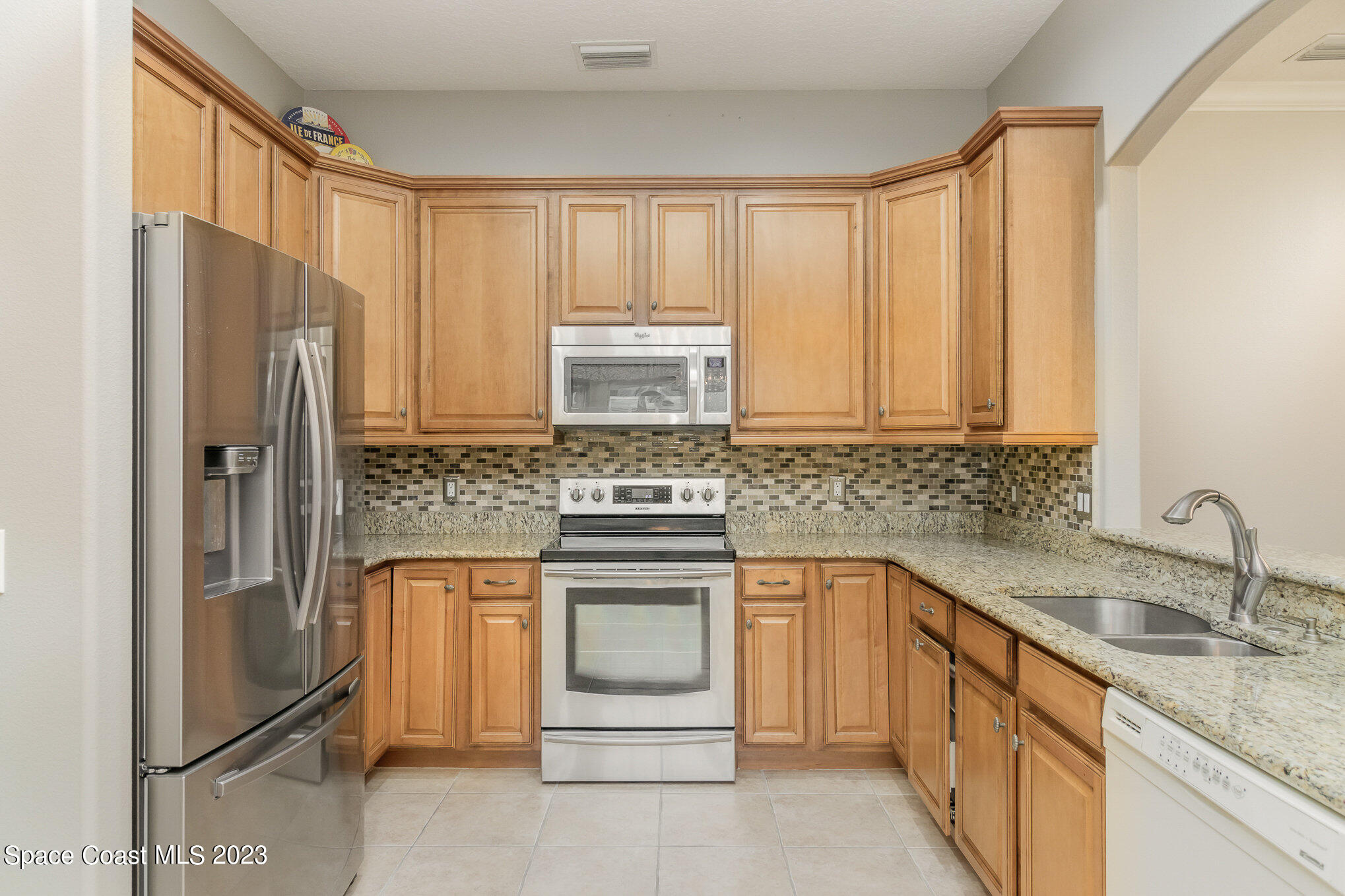 4250 Alamanda Key Drive Melbourne, FL 32901 - Photo 15 of 33 a kitchen with stainless steel appliances granite countertop a refrigerator sink and stove