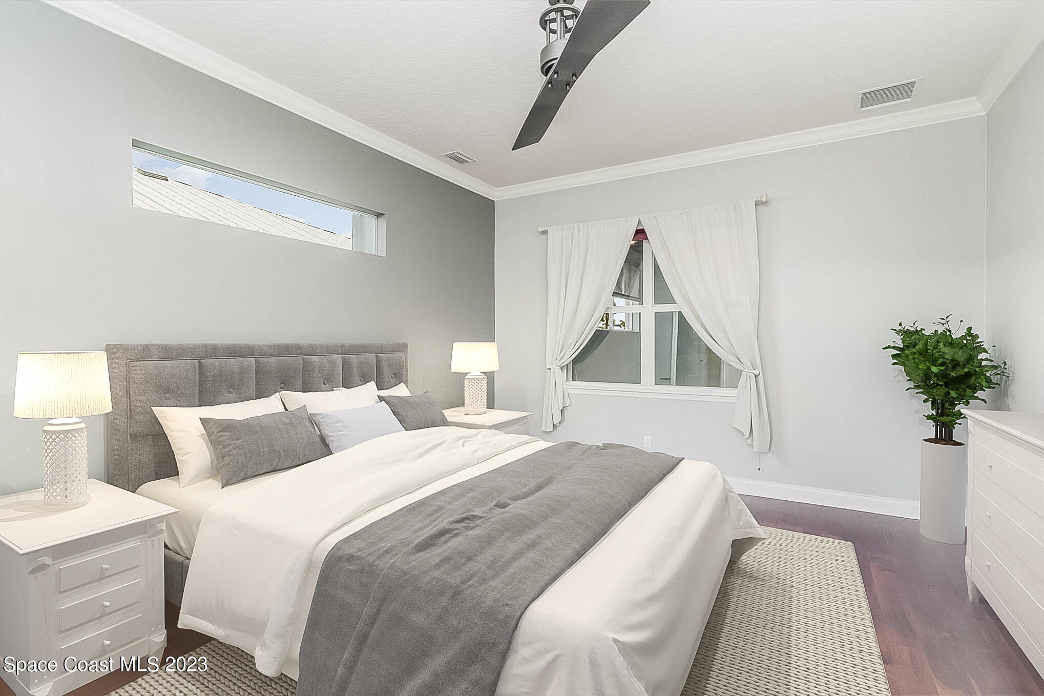 4250 Alamanda Key Drive Melbourne, FL 32901 - Photo 17 of 33 a bedroom with a bed and a potted plant