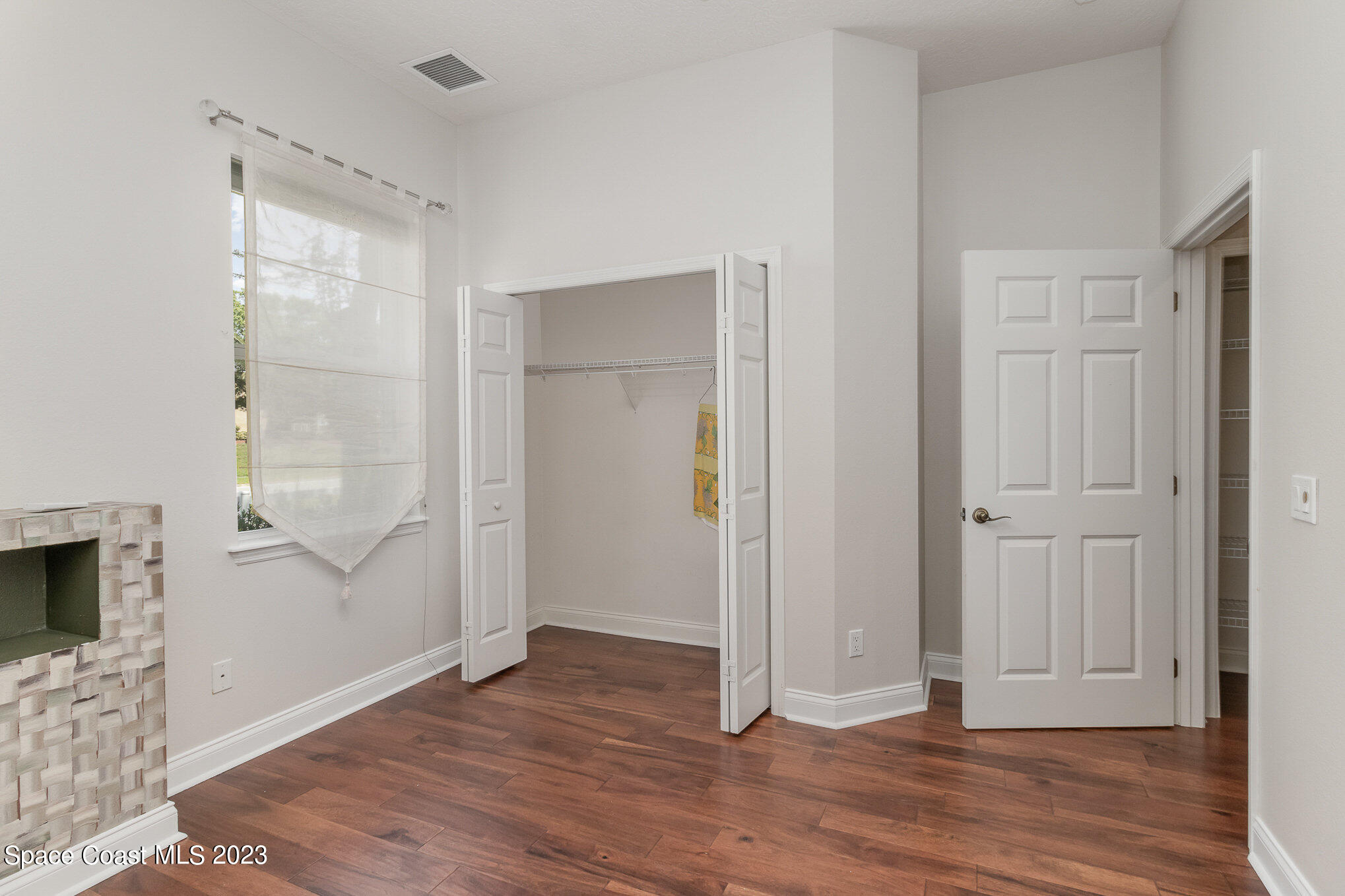 4250 Alamanda Key Drive Melbourne, FL 32901 - Photo 23 of 33 a view of empty room with wooden floor and fan
