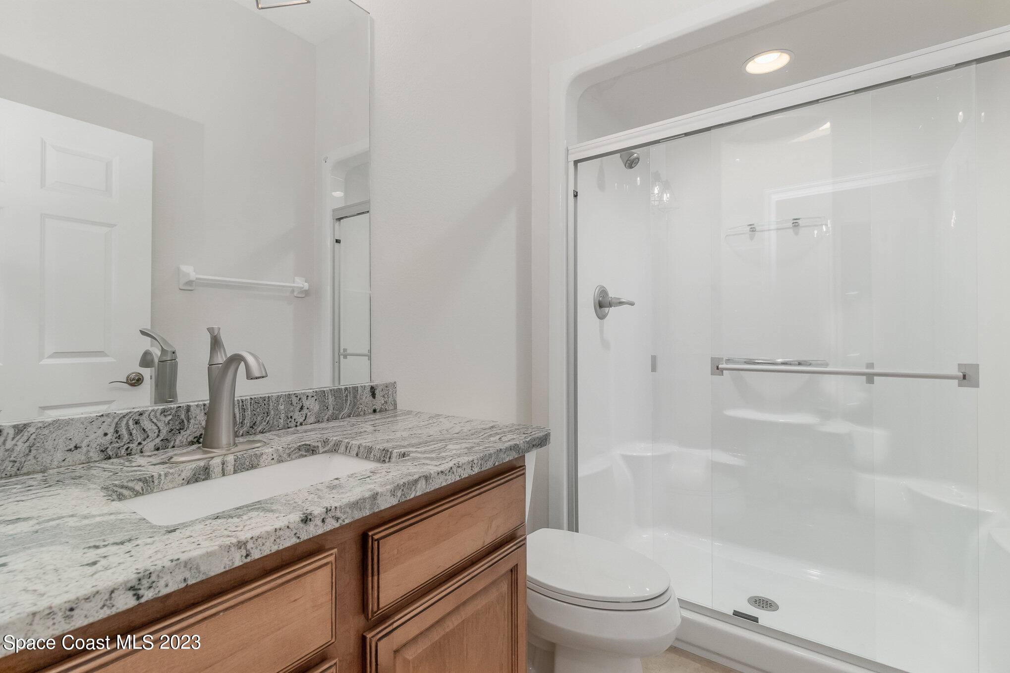 4250 Alamanda Key Drive Melbourne, FL 32901 - Photo 26 of 33 a bathroom with a granite countertop sink toilet and shower