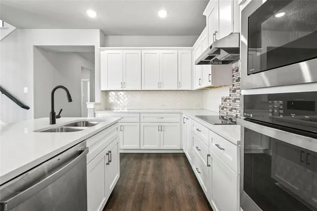 a living room with couch and a wooden floor