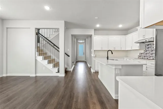 a view of entryway with wooden floor and stairs