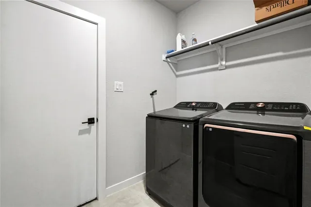 a utility room with washer and dryer