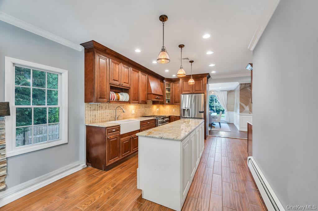 357 Wynsum Avenue Merrick, NY 11566 - Photo 19 of 40 a kitchen with stainless steel appliances granite countertop a stove and a wooden floors