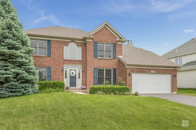 1805 Marne Road Bolingbrook, IL 60490 - Photo 1 of 27 a front view of a house with a yard and garage