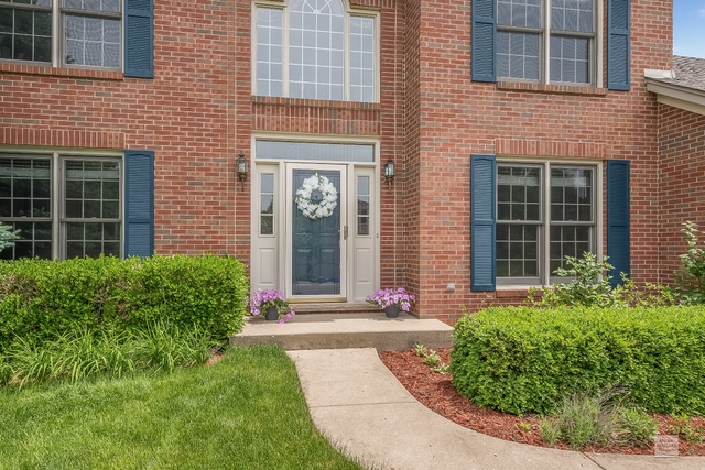 1805 Marne Road Bolingbrook, IL 60490 - Photo 2 of 27 a front view of a brick house with a yard