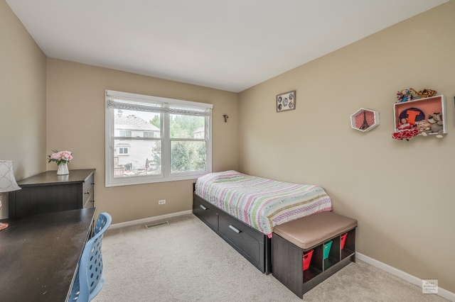 1805 Marne Road Bolingbrook, IL 60490 - Photo 20 of 27 a room with a bed and a window